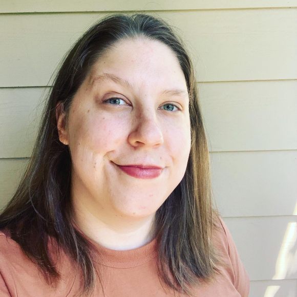 Photo of Anna, a white person with shoulder-length blonde hair